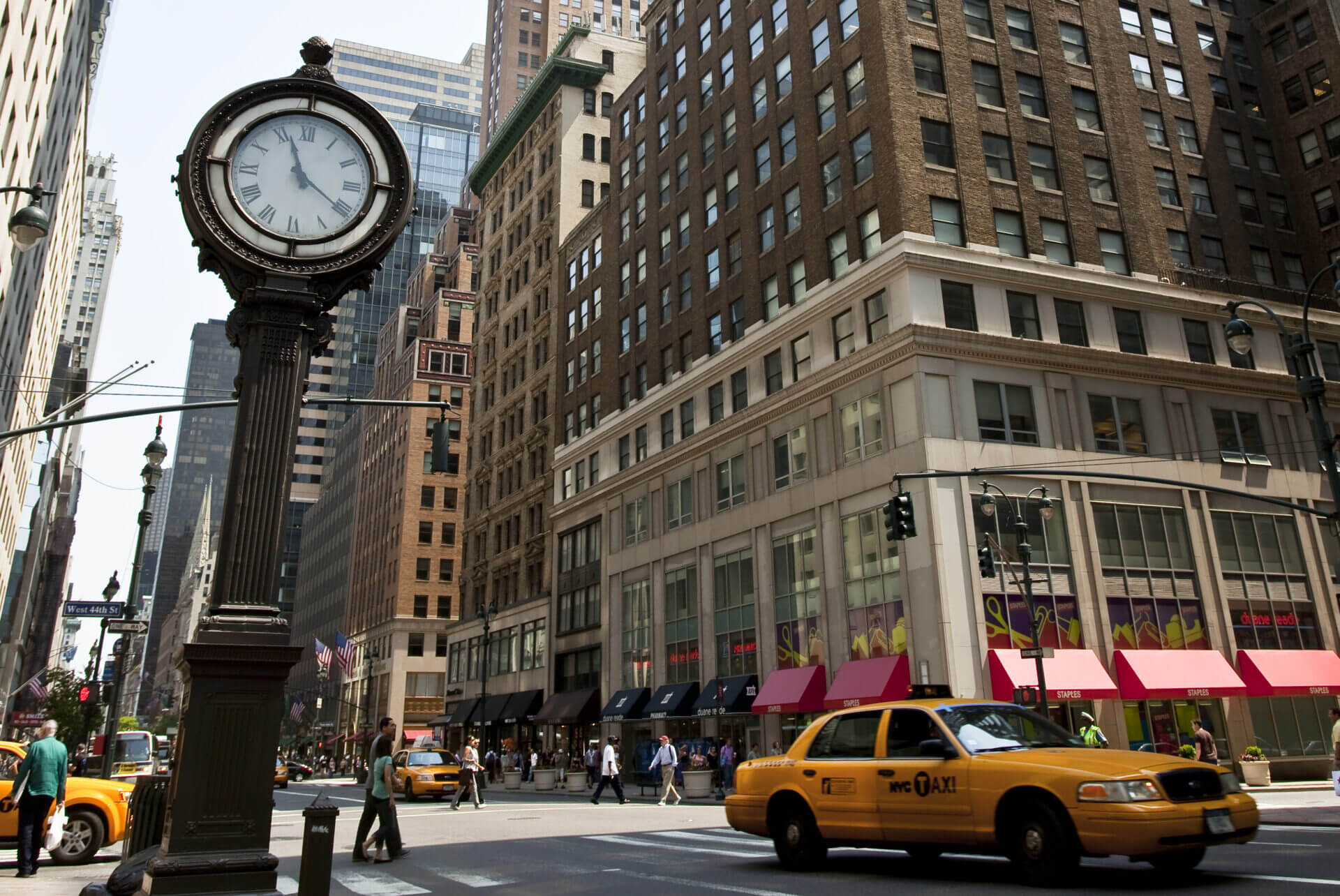New York city cross street showing retail shop on corner.
